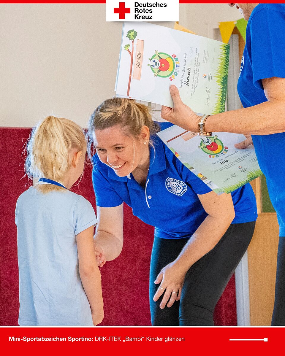 Ein Kind erhält von Trainerin Vanessa Hoffmann, Geschäftsführerin des Kreissportbundes Jerichower Land (KSB), die Urkunde für das bestandene Mini-Sportabzeichen Sportino.